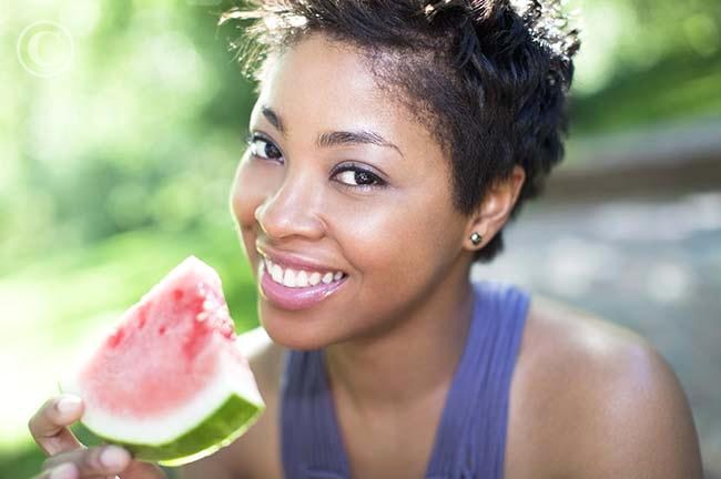 Black woman eating watermelon