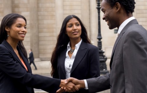 A business woman and man are shaking hands