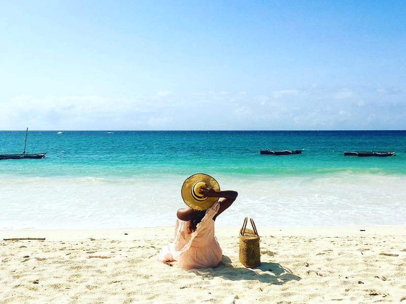 nigerian traveller on beach