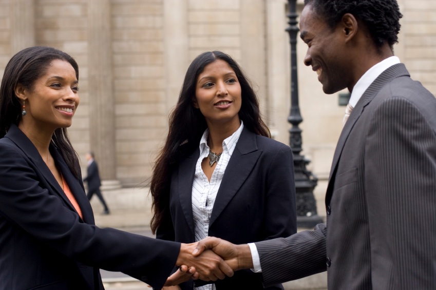 A business woman and man are shaking hands business